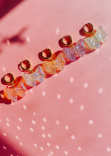 Load image into Gallery viewer, row of 5 Bow earrings. Made of acrylic with iridescent tint and sparkles.